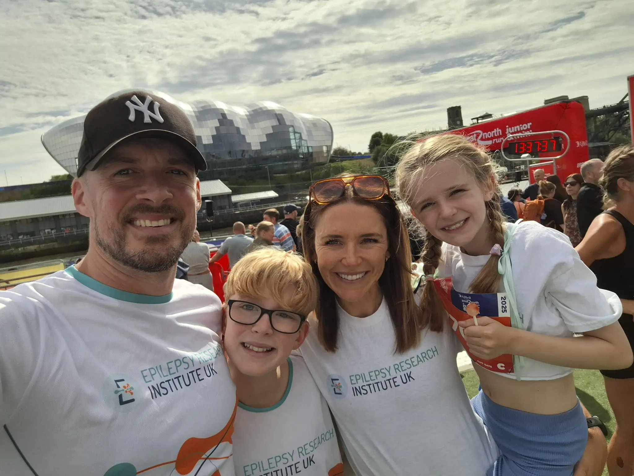 Carly and her family with the Newcastle skyline behind them after doing the Great North Run